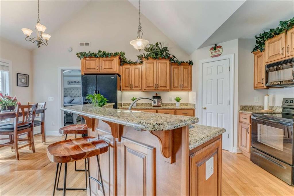 9 Royal Oak Drive Northeast Rome, GA 30165 - Photo 8 of 31 a kitchen with granite countertop a table chairs stove and granite counter tops