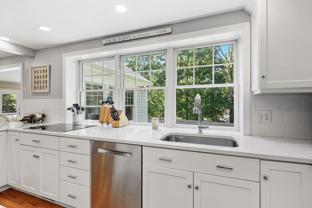 65 Bel Air Road Hingham, MA 02043 - Photo 13 of 35 a kitchen with sink windows and cabinets