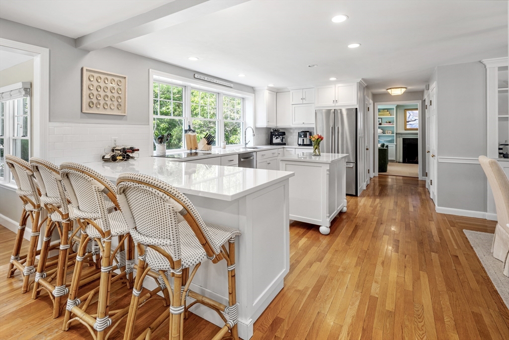 65 Bel Air Road Hingham, MA 02043 - Photo 16 of 35 a large white kitchen with lots of counter top space a sink and stainless steel appliances
