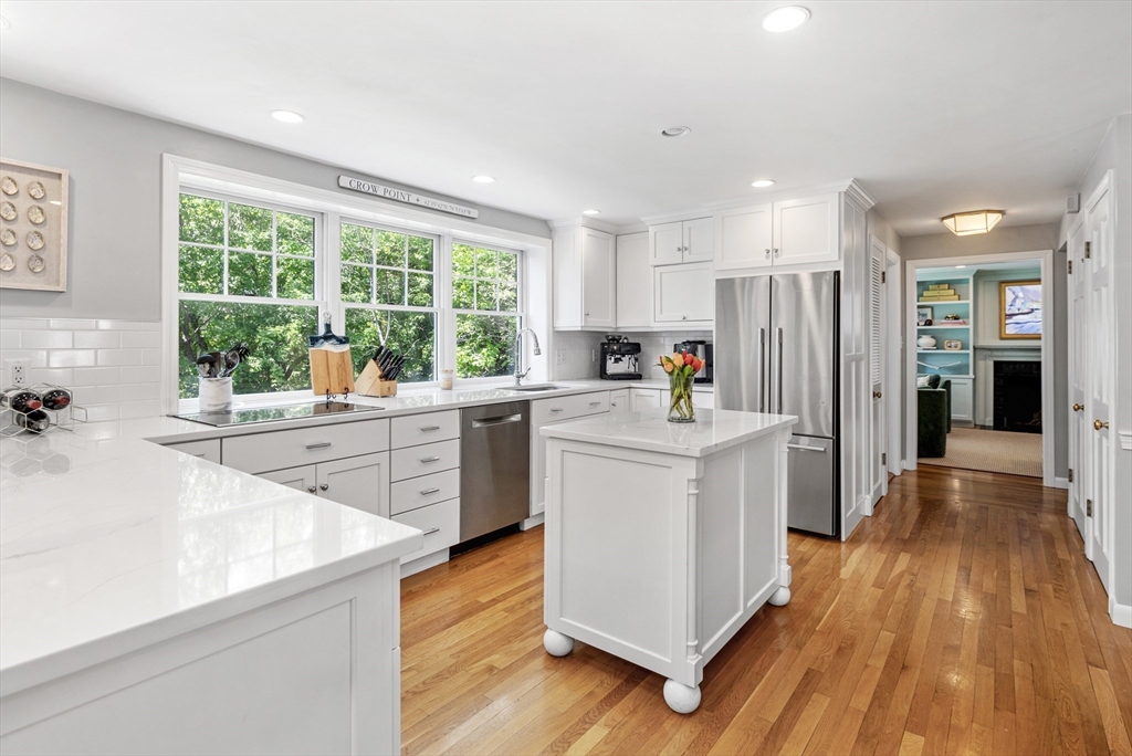 65 Bel Air Road Hingham, MA 02043 - Photo 17 of 35 a kitchen with a sink a counter top space stainless steel appliances a large window and a counter space