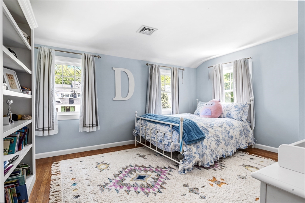 65 Bel Air Road Hingham, MA 02043 - Photo 24 of 35 a bedroom with a bed and a book shelf
