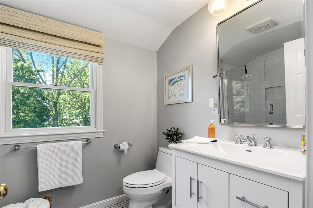 65 Bel Air Road Hingham, MA 02043 - Photo 27 of 35 a bathroom with a toilet a sink a mirror a window and vanity