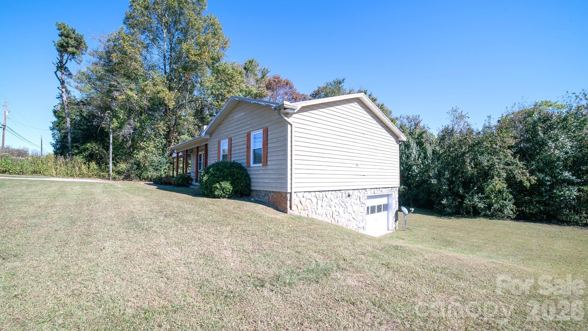 4186 Horseshoe Bend Road Hudson, NC 28638 - Photo 17 of 22 a view of a house with a yard and garage