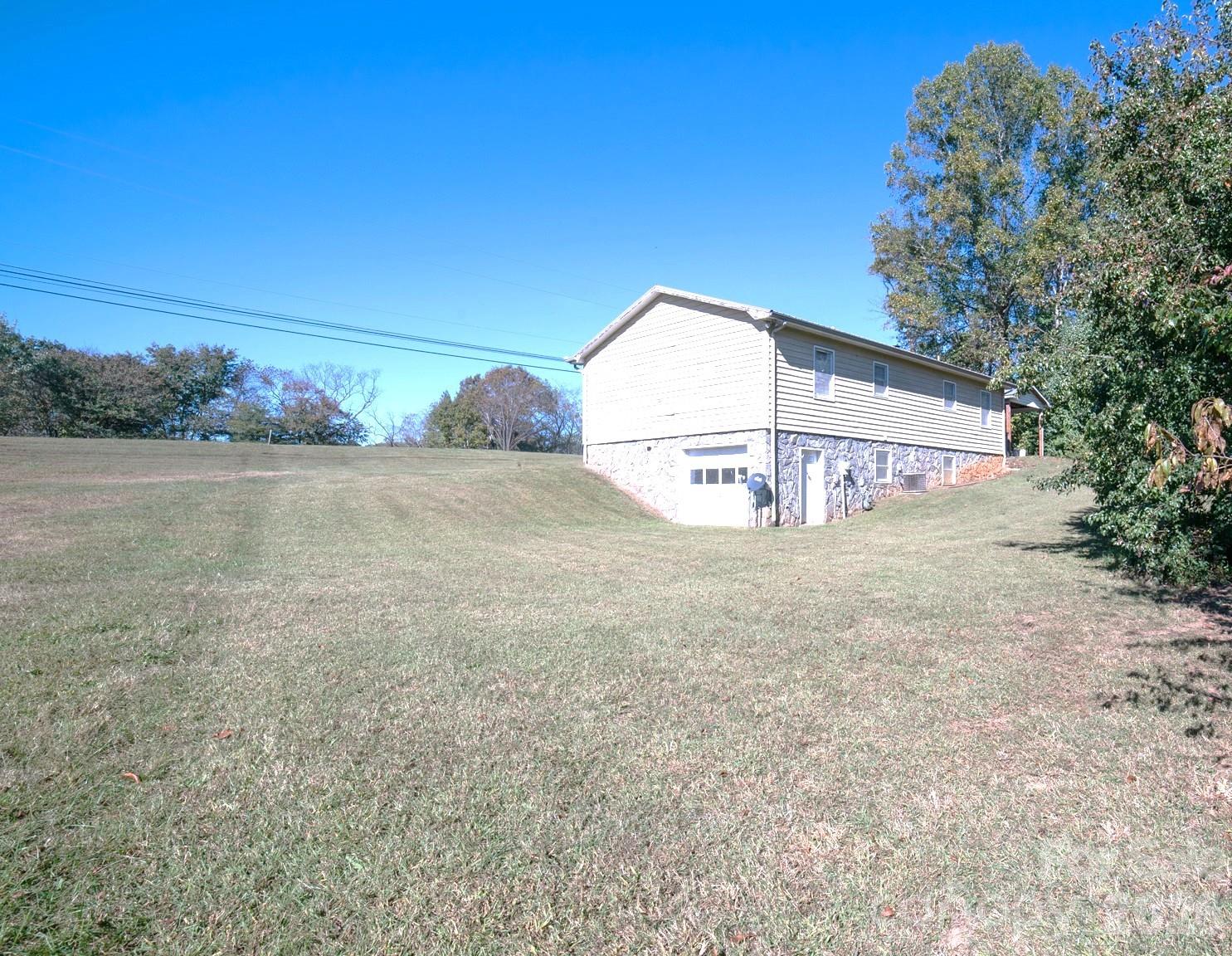 4186 Horseshoe Bend Road Hudson, NC 28638 - Photo 22 of 22 a view of a house with a yard