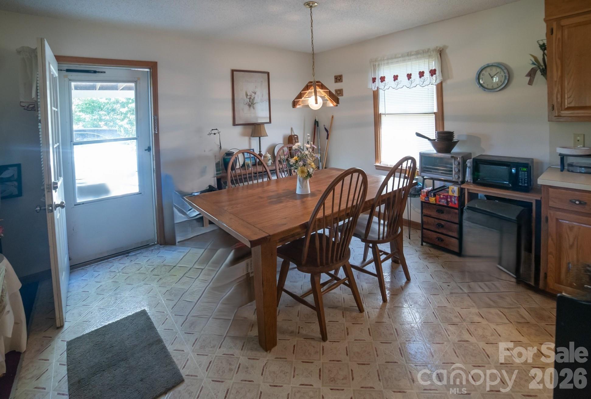 4186 Horseshoe Bend Road Hudson, NC 28638 - Photo 6 of 22 a view of a dining room and livingroom with furniture wooden floor a rug and a chandelier