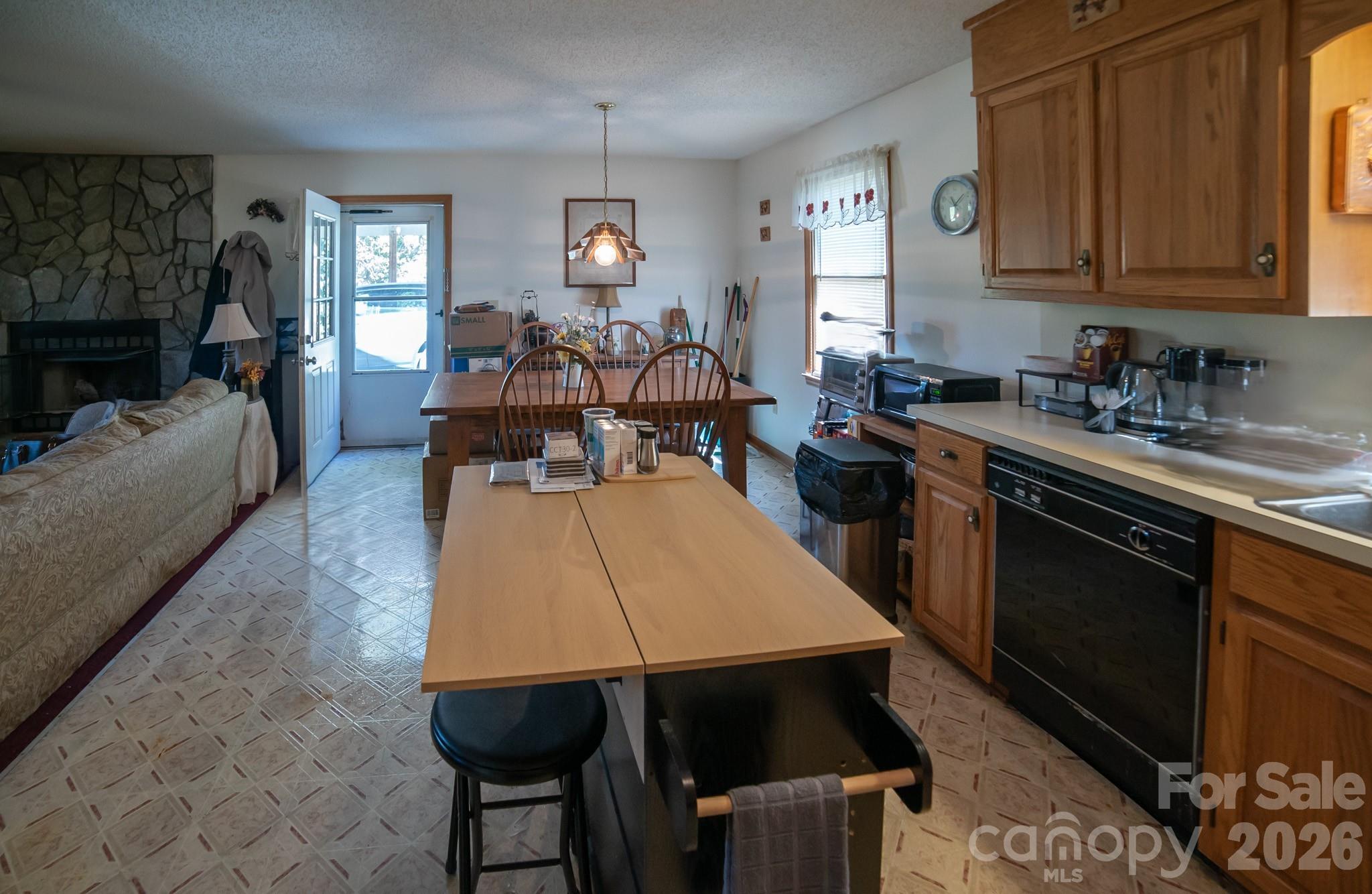 4186 Horseshoe Bend Road Hudson, NC 28638 - Photo 7 of 22 a kitchen with a table chairs and a wooden cabinets