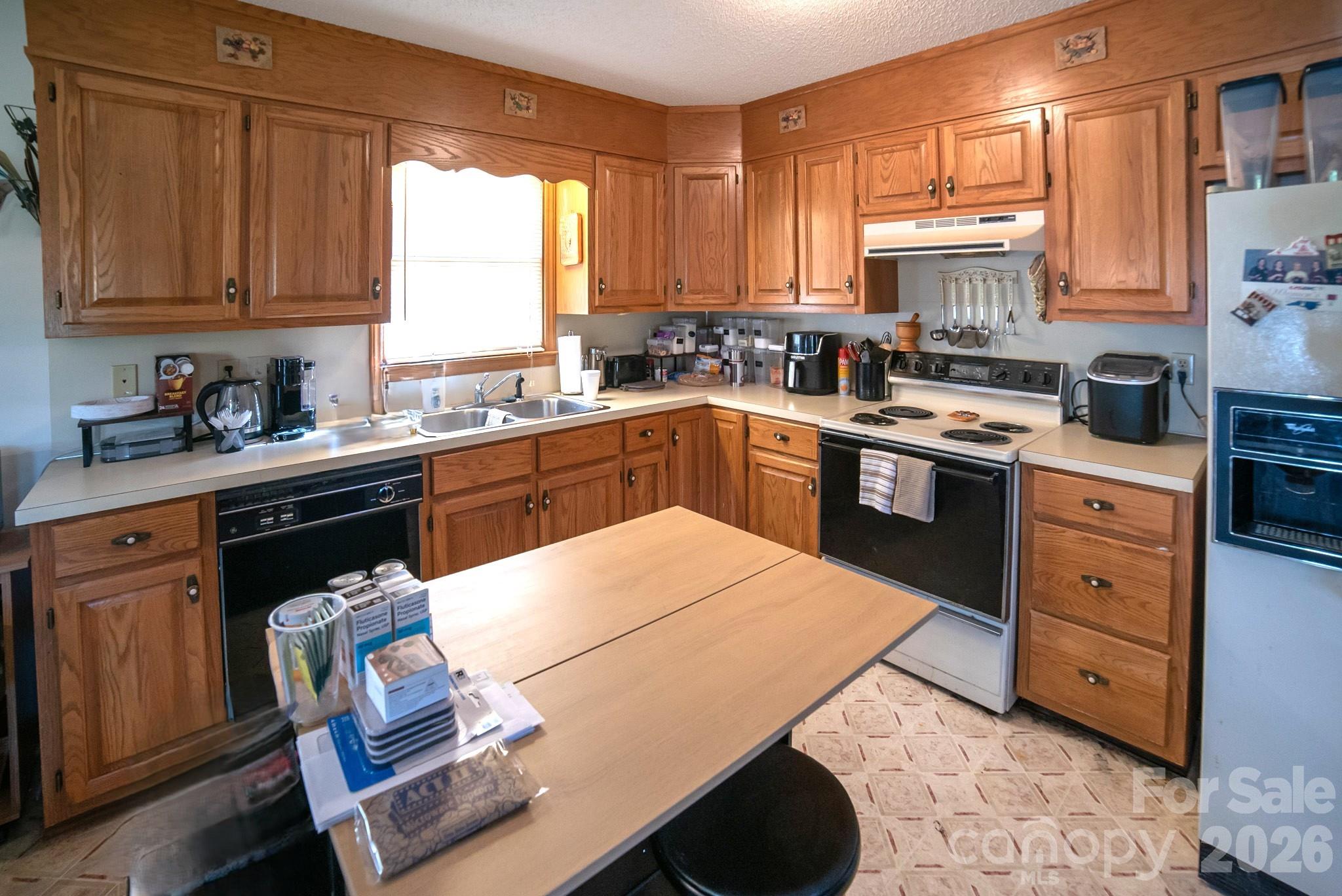 4186 Horseshoe Bend Road Hudson, NC 28638 - Photo 8 of 22 a kitchen with stainless steel appliances granite countertop a stove a sink dishwasher and cabinets with wooden floor