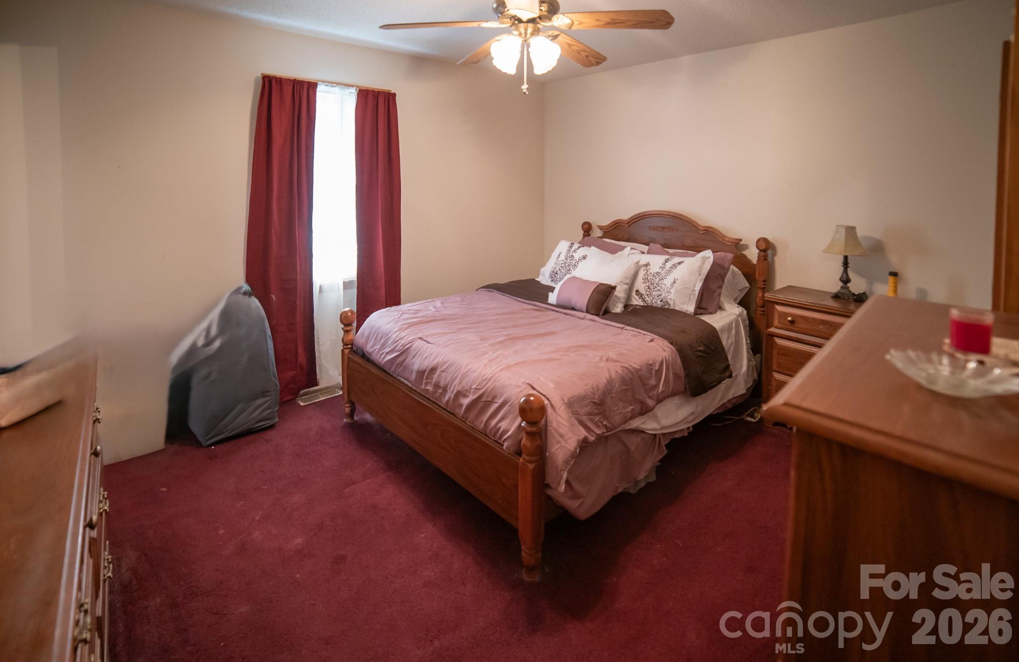 4186 Horseshoe Bend Road Hudson, NC 28638 - Photo 10 of 22 a bedroom with a bed and a chandelier