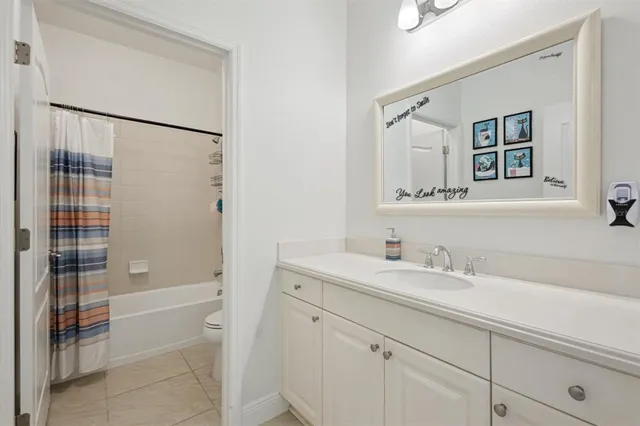 a bathroom with a shower sink and mirror