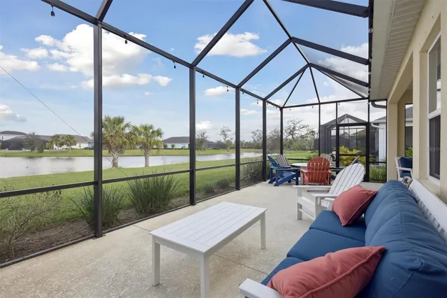 a bedroom with furniture and a large window