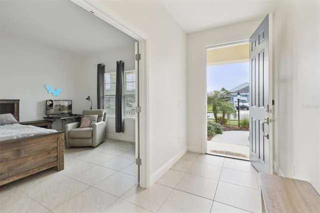 a view of a livingroom with furniture and floor to ceiling window