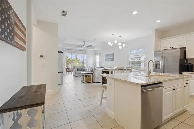 a kitchen with stainless steel appliances kitchen island granite countertop a sink and cabinets
