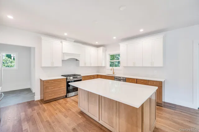 a kitchen with a stove a sink and a refrigerator