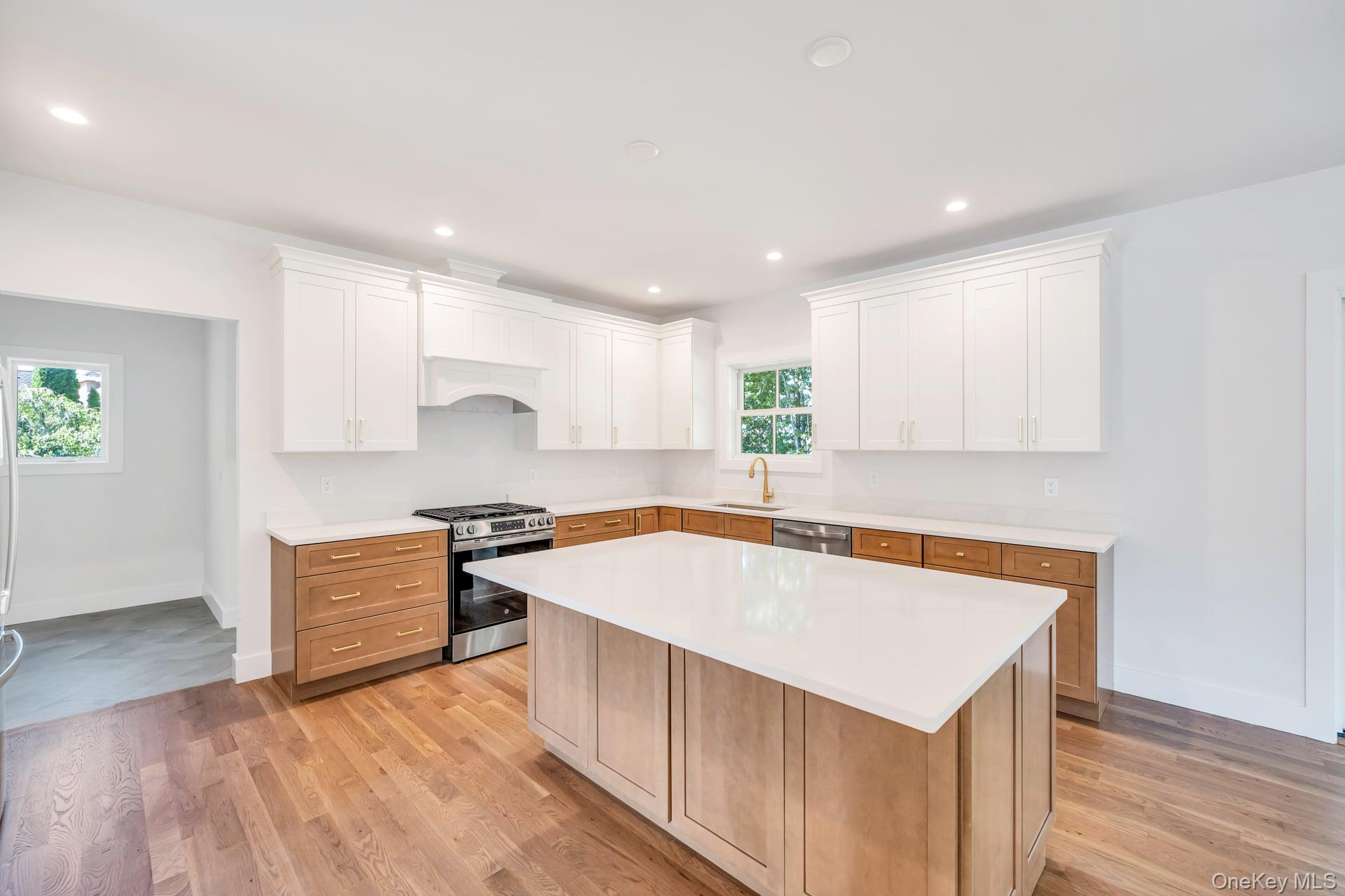 84 James Hawkins Road Moriches, NY 11955 - Photo 15 of 50 a kitchen with a stove a sink and a refrigerator