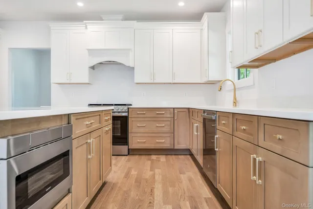 a kitchen with granite countertop white cabinets and white appliances