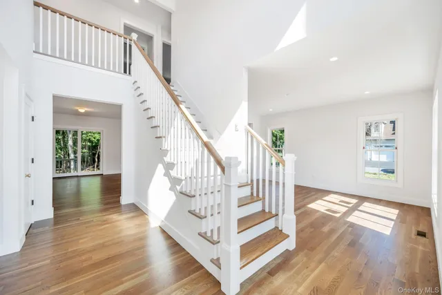 a view of entryway and hall with wooden floor