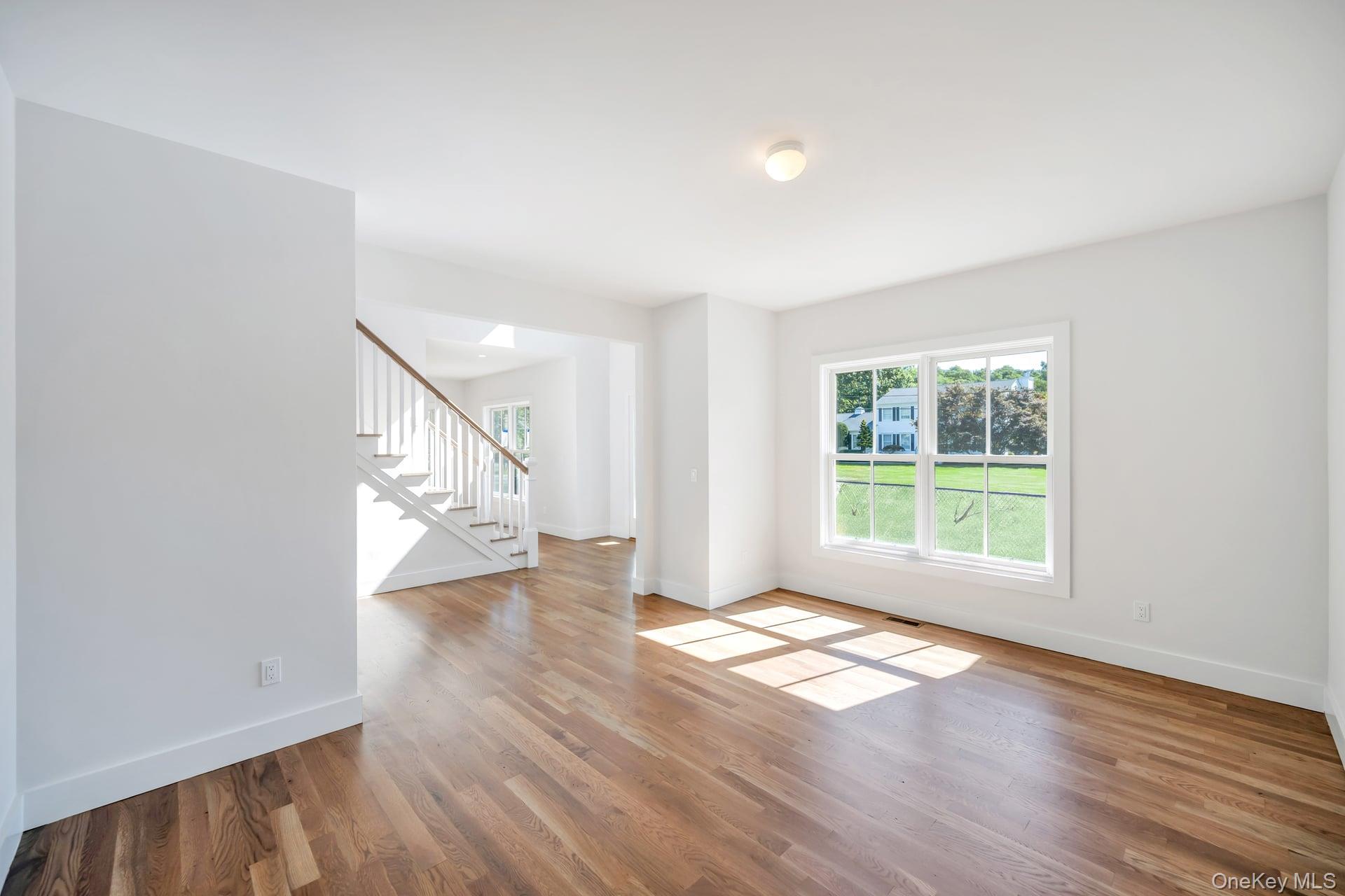 84 James Hawkins Road Moriches, NY 11955 - Photo 23 of 50 a view of an empty room with wooden floor and a window