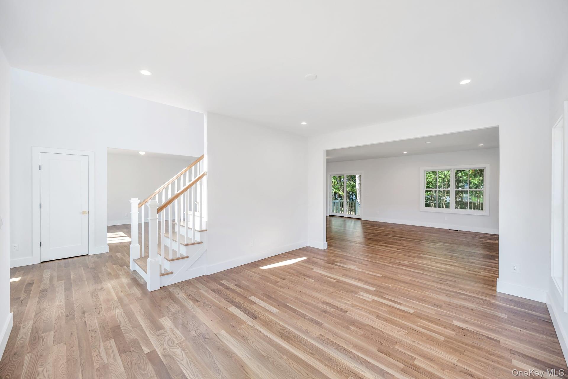 84 James Hawkins Road Moriches, NY 11955 - Photo 27 of 50 a view of an empty room with wooden floor and a window