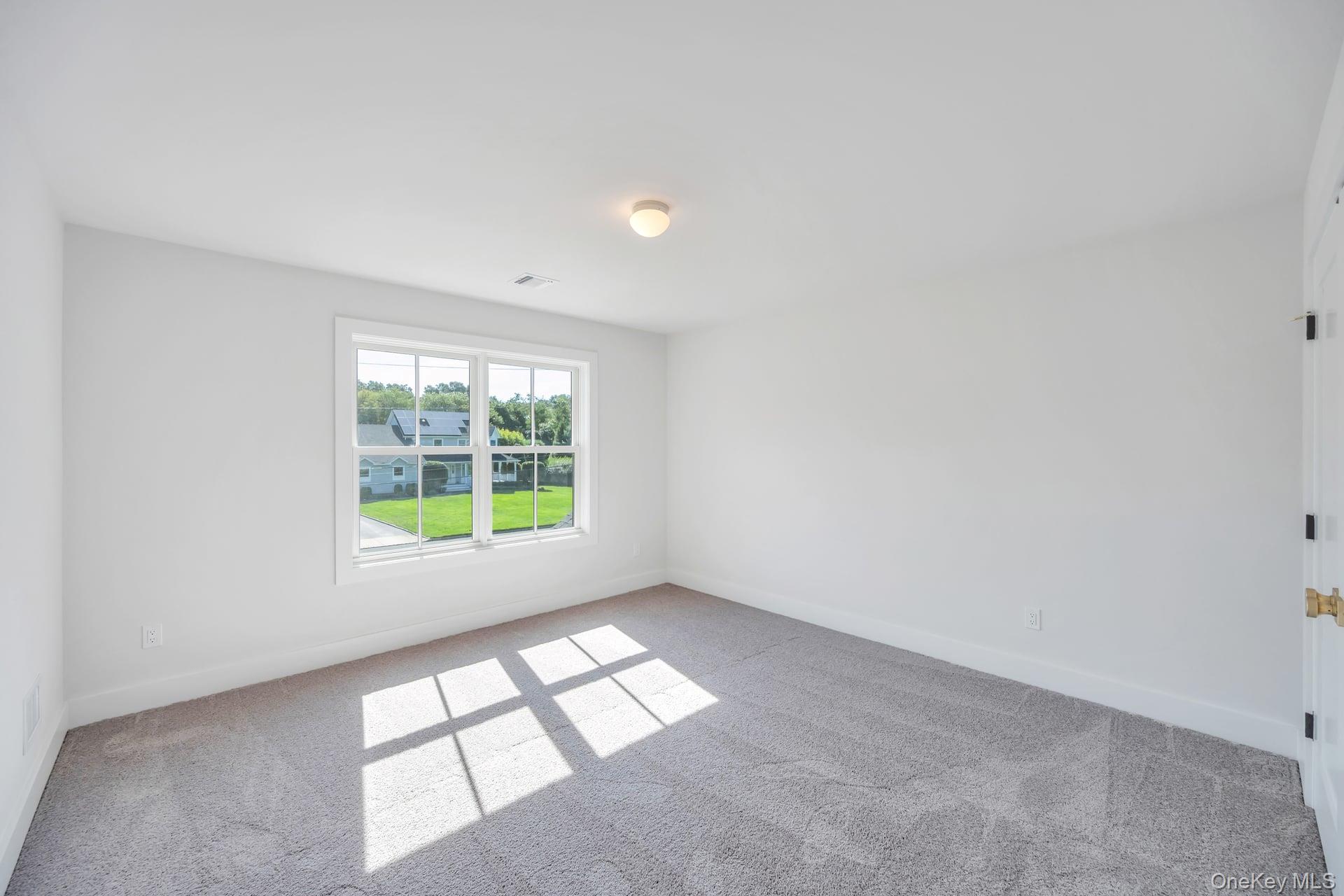 84 James Hawkins Road Moriches, NY 11955 - Photo 40 of 50 a view of an empty room with a window