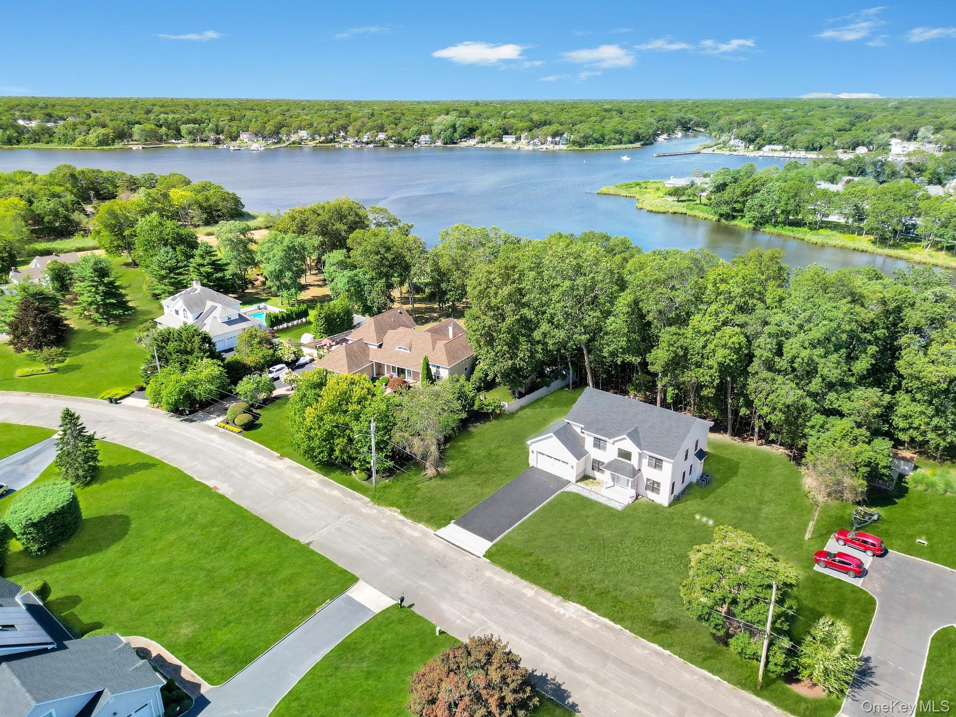 84 James Hawkins Road Moriches, NY 11955 - Photo 7 of 50 a view of a lake with a city