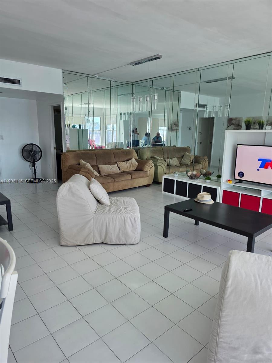 9102 West Bay Harbor Drive, Unit 4C Bay Harbor Islands, FL 33154 - Photo 11 of 26 a living room with furniture and a window