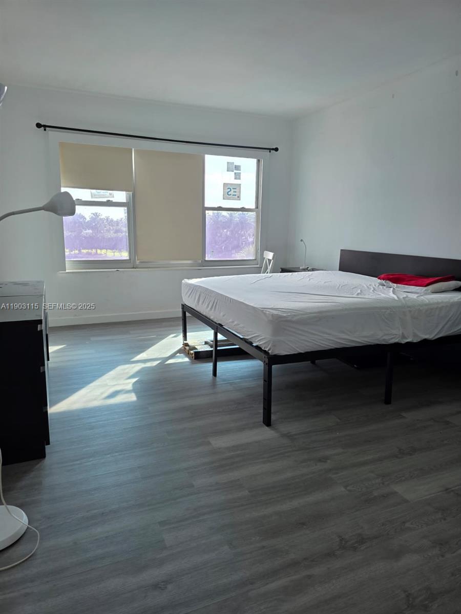 9102 West Bay Harbor Drive, Unit 4C Bay Harbor Islands, FL 33154 - Photo 12 of 26 a room with wooden floor and table