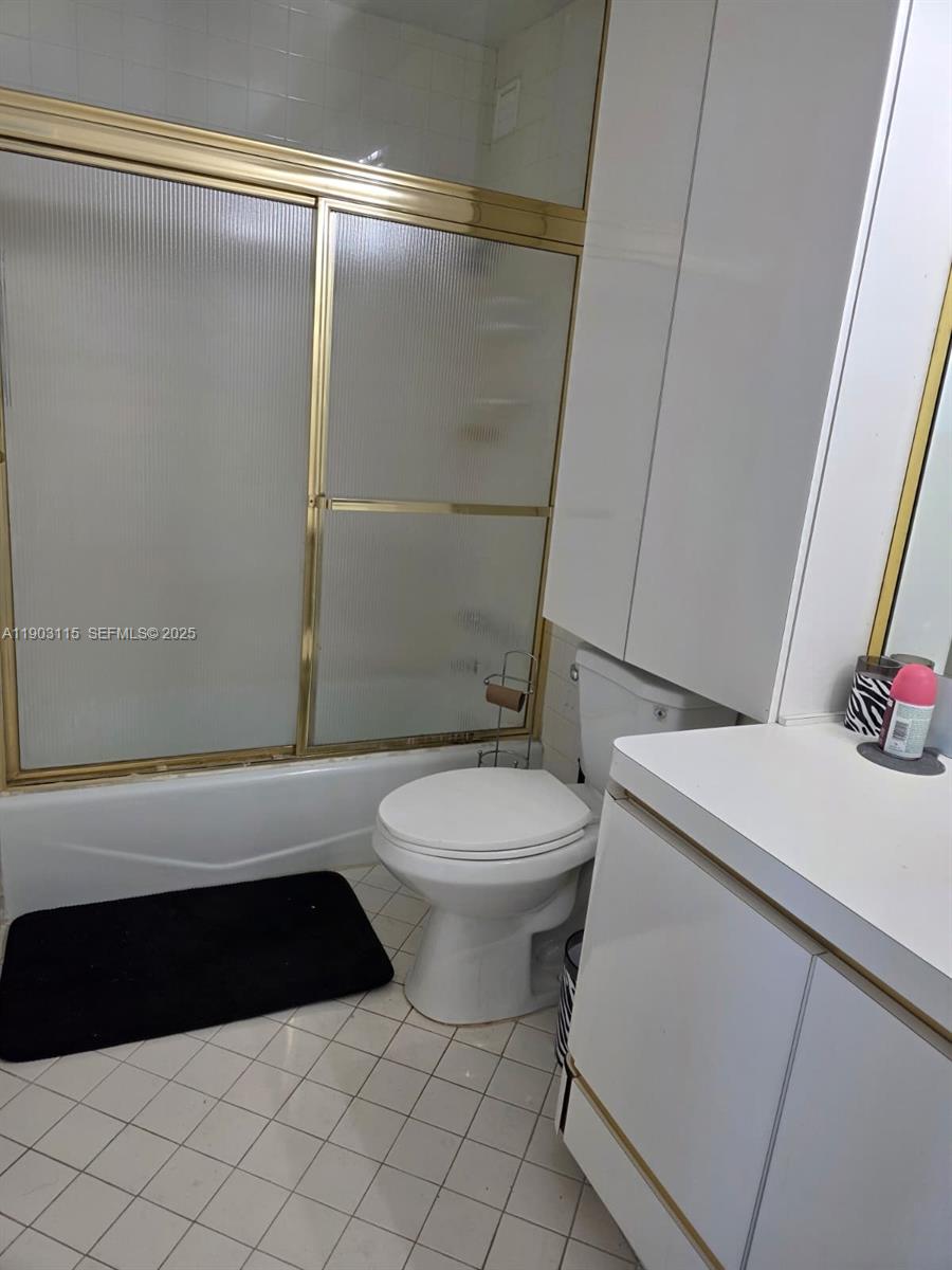 9102 West Bay Harbor Drive, Unit 4C Bay Harbor Islands, FL 33154 - Photo 13 of 26 a bathroom with a toilet a sink and a shower