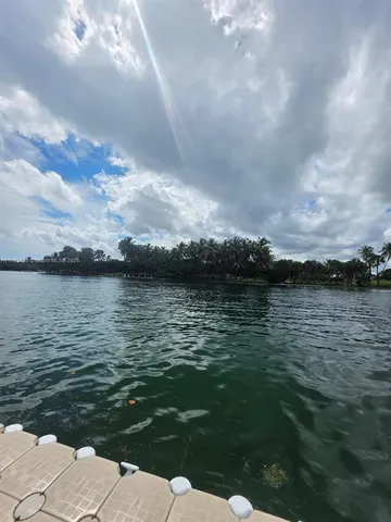 a view of a lake with houses in the back