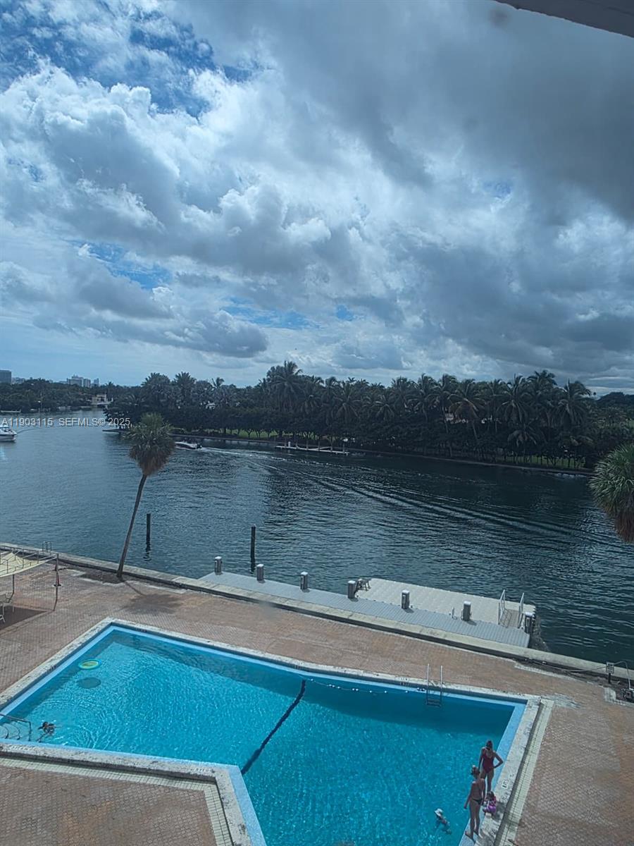 9102 West Bay Harbor Drive, Unit 4C Bay Harbor Islands, FL 33154 - Photo 25 of 26 a view of a lake with houses in the back
