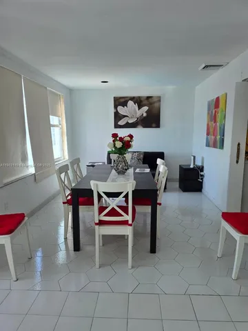 a living room with furniture a rug and a window