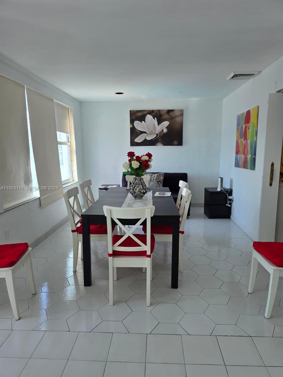 9102 West Bay Harbor Drive, Unit 4C Bay Harbor Islands, FL 33154 - Photo 10 of 26 a living room with furniture a rug and a window