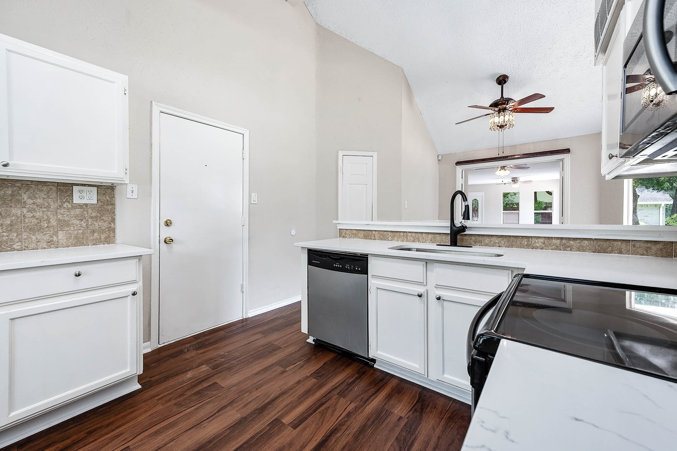 915 West Primrose Meadows Circle Pearland, TX 77584 - Photo 13 of 31 a kitchen with a sink cabinets and wooden floor