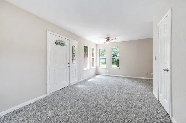an empty room with windows and closet