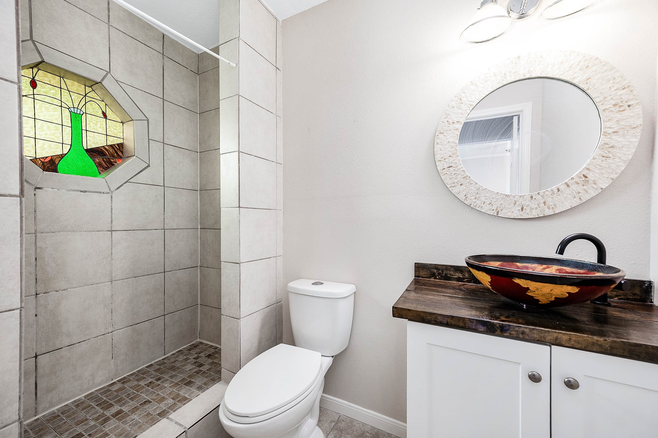 915 West Primrose Meadows Circle Pearland, TX 77584 - Photo 22 of 31 a bathroom with a granite countertop toilet and a sink