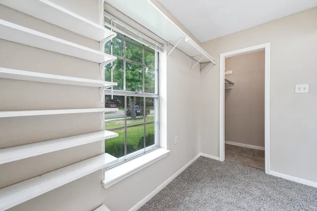 a view of small space with wooden floor and windows