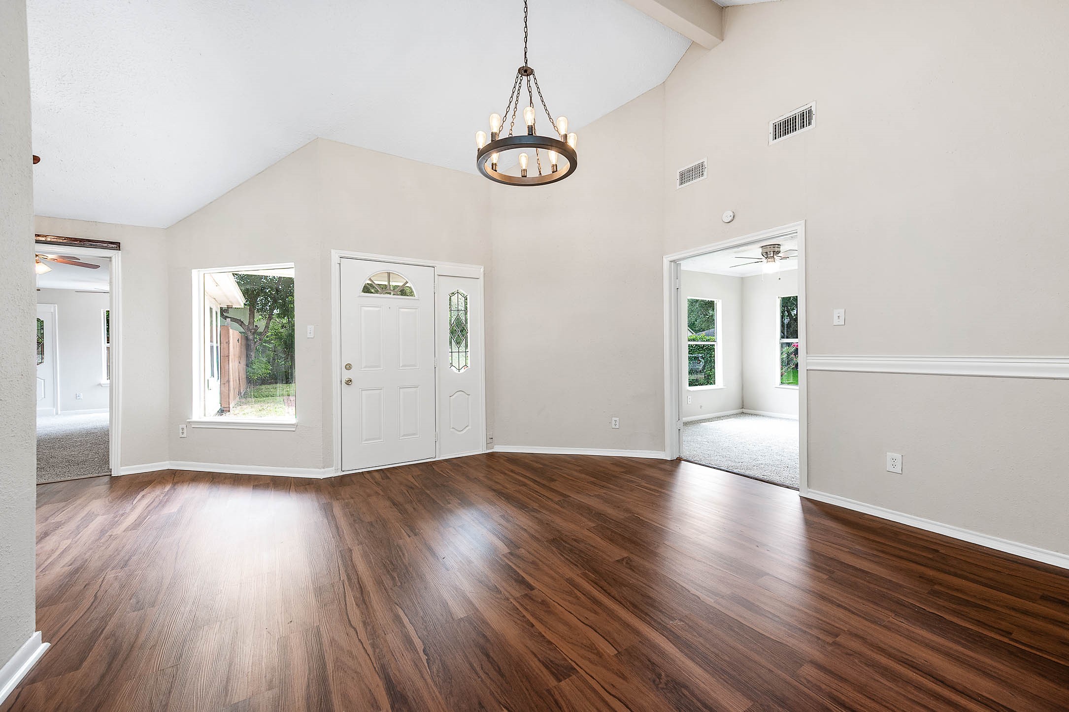 915 West Primrose Meadows Circle Pearland, TX 77584 - Photo 5 of 31 a view of an empty room with wooden floor and a window