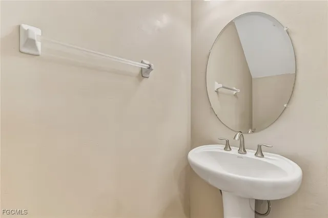 a bathroom with a sink a mirror and a shower