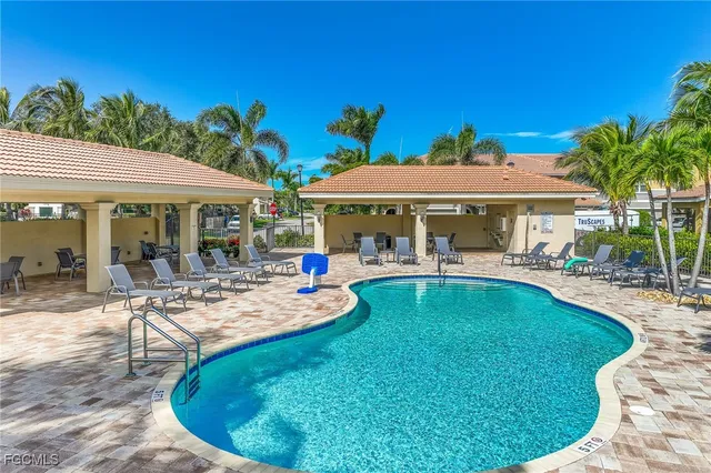 a view of a swimming pool with lounge chairs