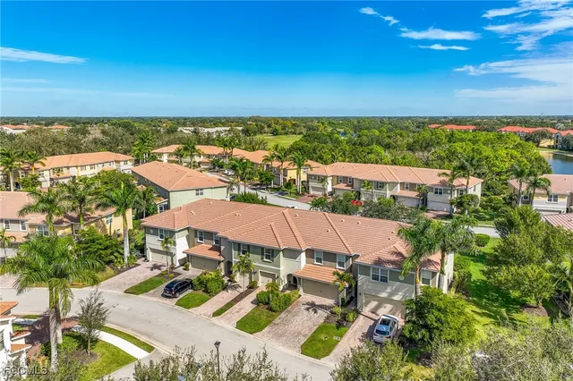 a view of a patio with lawn chairs under an umbrella