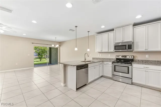 a kitchen with granite countertop a stove sink and cabinets