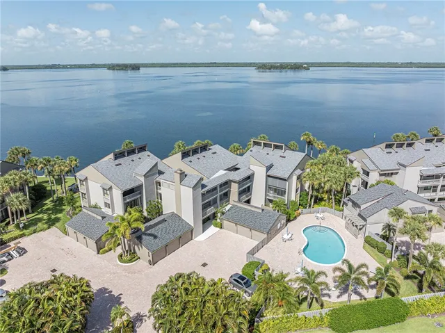 an aerial view of a house with outdoor seating
