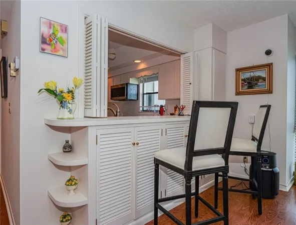 a living room with furniture a flat screen tv and a floor to ceiling window