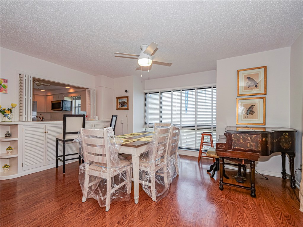 1001 Bay Road, Unit 205 Vero Beach, FL 32963 - Photo 16 of 36 a view of a dining room with furniture window and wooden floor