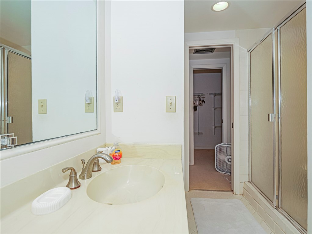 1001 Bay Road, Unit 205 Vero Beach, FL 32963 - Photo 21 of 36 a bathroom with a sink and a mirror