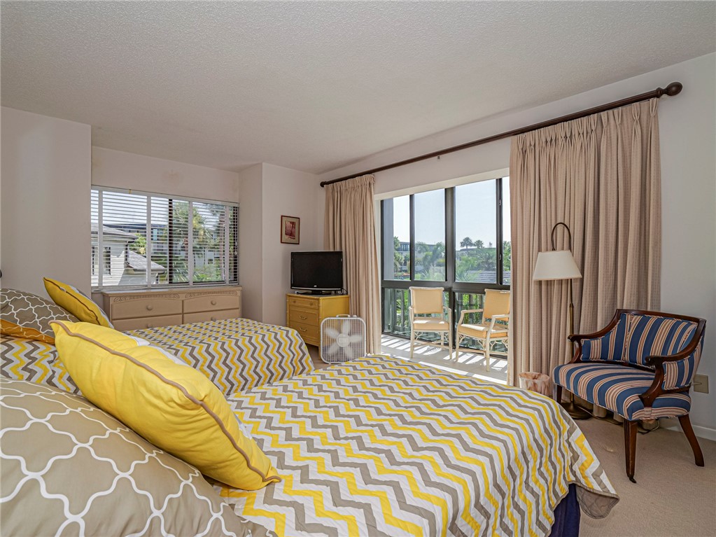 1001 Bay Road, Unit 205 Vero Beach, FL 32963 - Photo 23 of 36 a bedroom with a bed and a large window