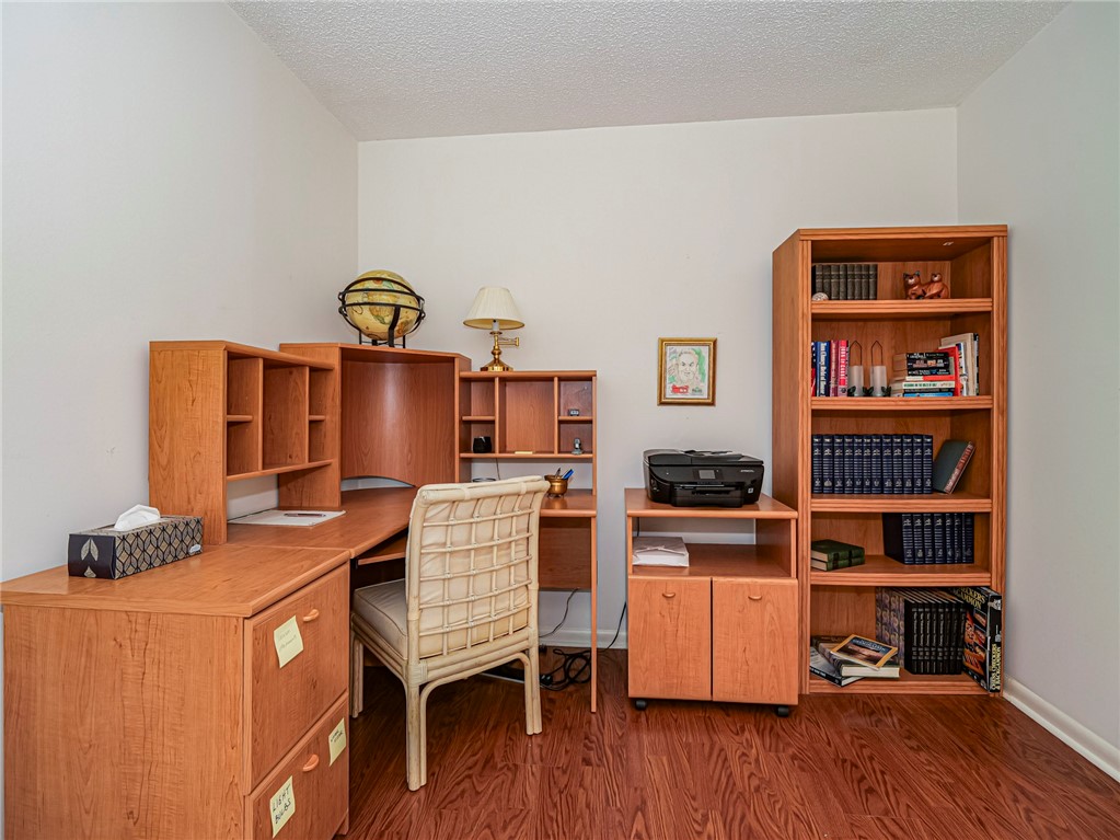 1001 Bay Road, Unit 205 Vero Beach, FL 32963 - Photo 27 of 36 a workspace with furniture and wooden floor
