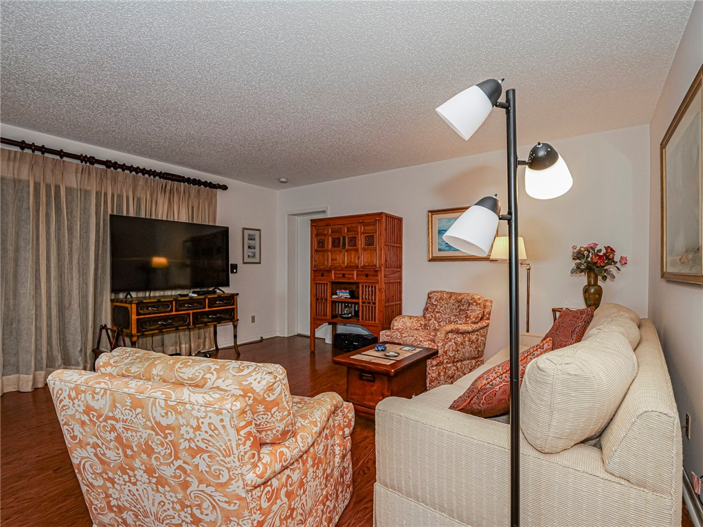 1001 Bay Road, Unit 205 Vero Beach, FL 32963 - Photo 8 of 36 a living room with furniture and a flat screen tv