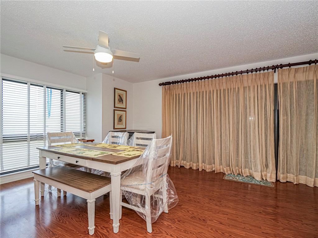 1001 Bay Road, Unit 205 Vero Beach, FL 32963 - Photo 10 of 36 a view of a dining room with furniture window and wooden floor