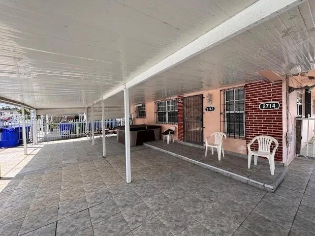 a kitchen with granite countertop a refrigerator and a stove top oven