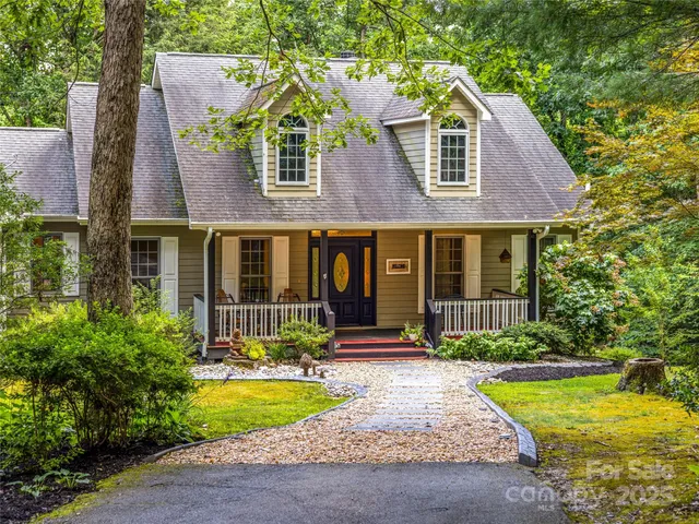a front view of a house with swimming pool and porch